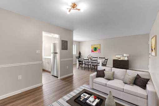 A living room with a white couch and a coffee table.