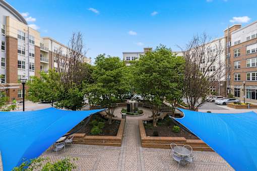 A courtyard with a blue tarp covering the ground.