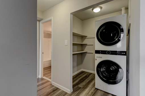 A white dryer is in a small laundry room.