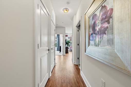 A long hallway with a painting on the wall.