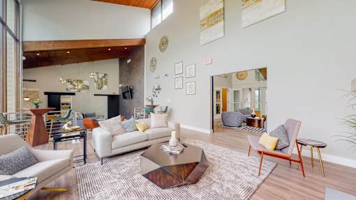 A living room with a white couch and a coffee table.