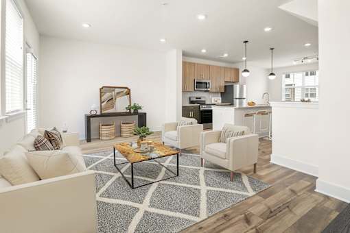 A modern living room with a coffee table in the center.