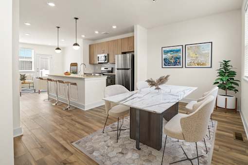 A modern kitchen with a dining table set for four.