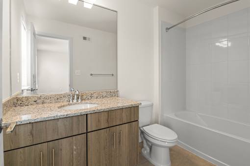 A bathroom with a sink, toilet, and bathtub.