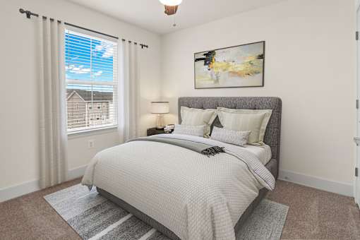 A bedroom with a large bed and a painting on the wall.