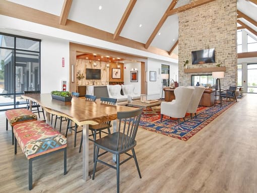 a living room with a wooden table and a fireplace