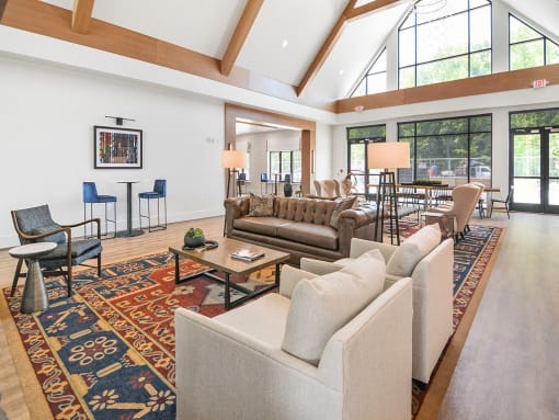 a large living room with couches and chairs and a large rug