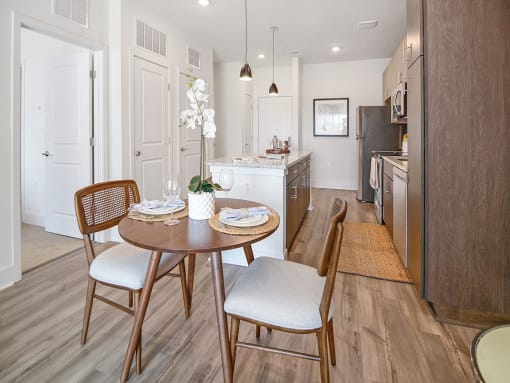 a kitchen and dining room with a table and chairs