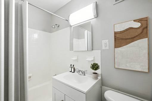 a small bathroom with a sink and a shower