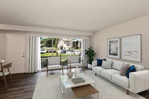 a living room with a white couch and a coffee table and a sliding glass door