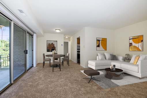 A modern living room with a dining table and a white couch.