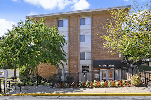 A brick building with a leasing office on the ground floor.