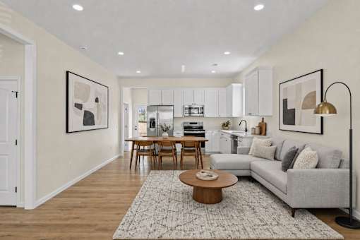 A modern living room with a grey sofa and a coffee table.