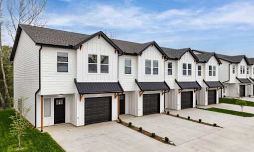A row of houses with garages in front.