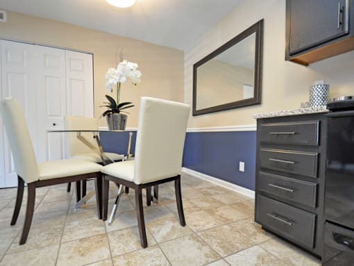 a dining room with a table and chairs and a tv
