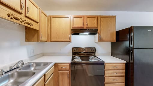 a kitchen with wooden cabinets and a stove and a sink