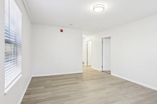 A room with a wooden floor and white walls.