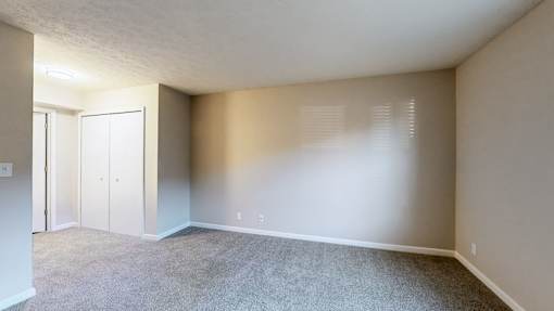 A room with carpeted floor and white walls.