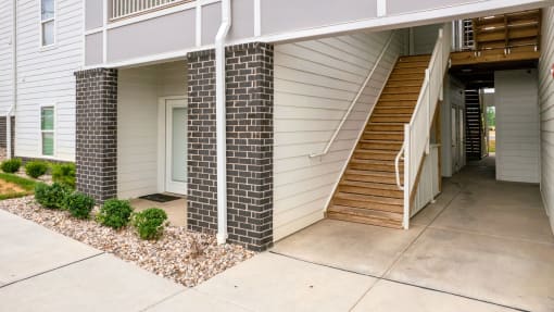 the front of a house with stairs and a sidewalk