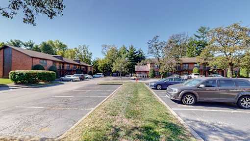 a street with cars parked in front of a building