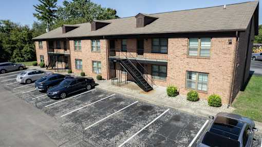 an apartment building with cars parked in front of it