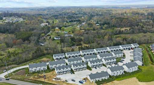 A large housing development with multiple houses and a road.