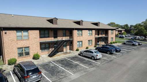 a large brick building with cars parked in front of it