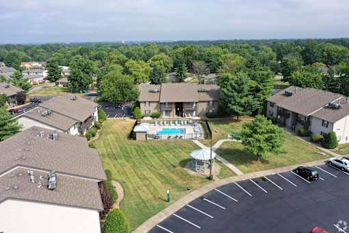 an aerial view of a neighborhood with houses and a swimming pool