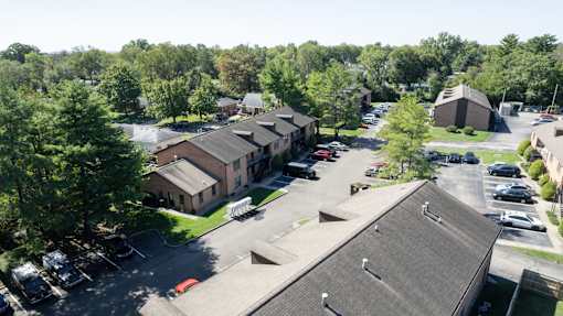 an aerial view of a parking lot and buildings