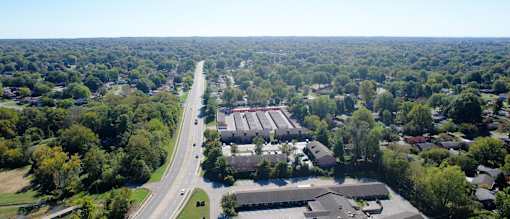 an aerial view of a city street and buildings and trees