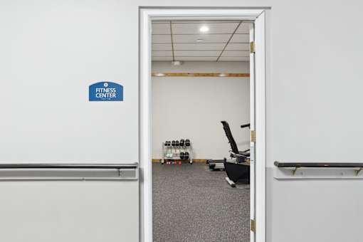A fitness center sign is on the wall.