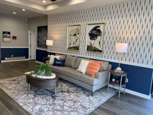 a living room with a couch and two paintings on the wall