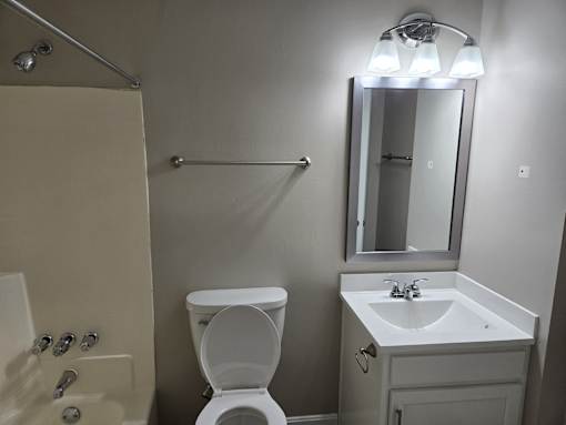 a small bathroom with a sink toilet and shower