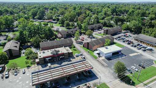 an aerial view of a parking lot and buildings in a city