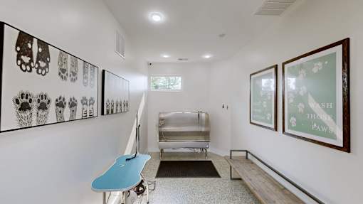 A room with a blue table and pictures on the wall.