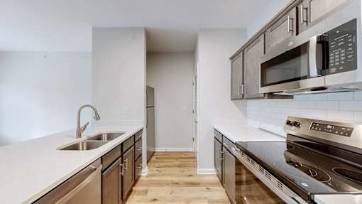 A kitchen with a stove top oven and microwave above it.