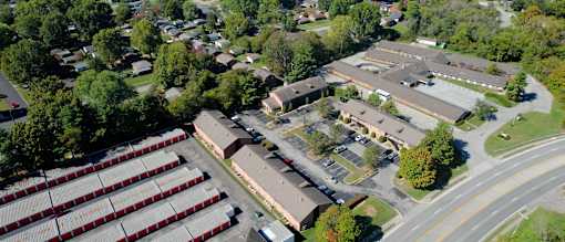 an aerial view of the campus with several buildings and a parking lot