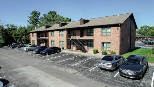a large brick building with cars parked in front of it