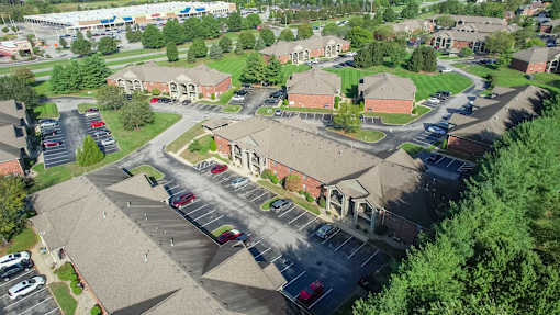 A parking lot is surrounded by apartment buildings.