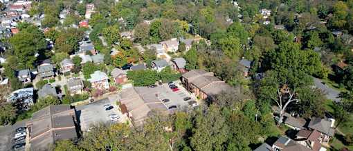 an aerial view of a neighborhood with houses and trees