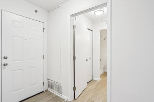 A white door with a silver handle is on the left side of the image.