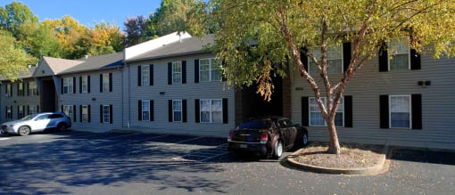 an apartment building with a car parked in front of it