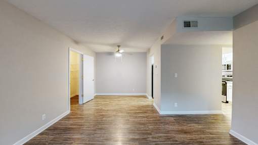 A room with wooden floors and white walls.
