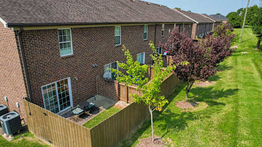 A brick house with a tree in front of it.