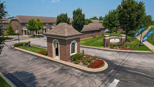 A small building with a brick facade and a green lawn in front.