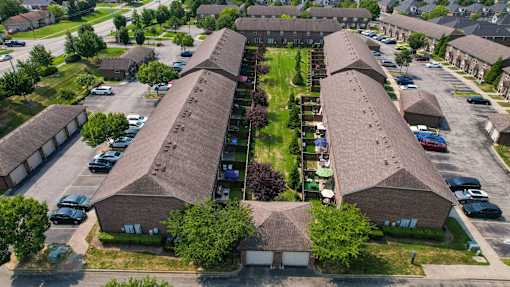 A bird's eye view of a residential area with houses and cars.