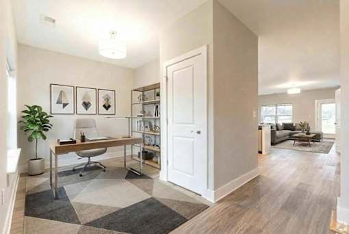 A room with a desk and a chair in it.