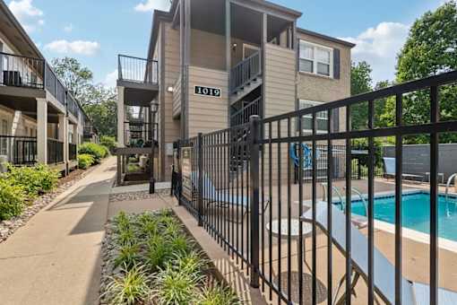 An apartment pool with black fence in Louisville