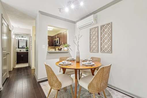 A dining room with round table and four chairs  at Avenue in the Highlands Apartments in Louisville