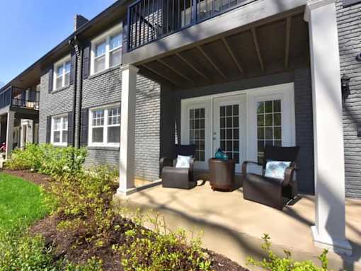 A porch with chairs and table  at Avenue in the Highlands Apartments in Louisville